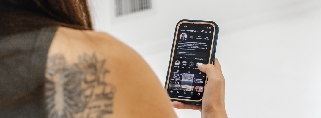 Marissa holding a phone - picture only shows phone screen and part of her back