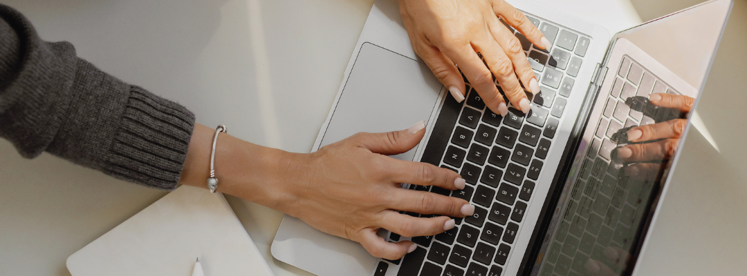 hands typing on a laptop