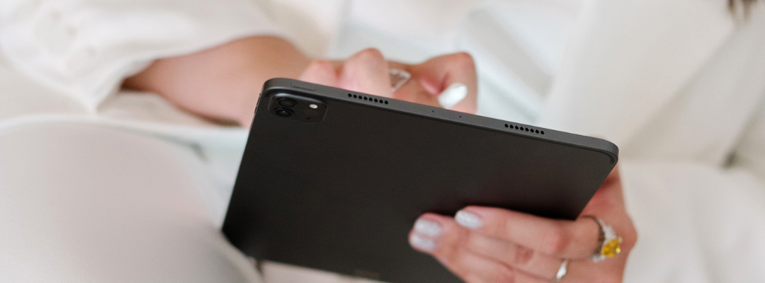 Close up of hands interacting with a black ipad